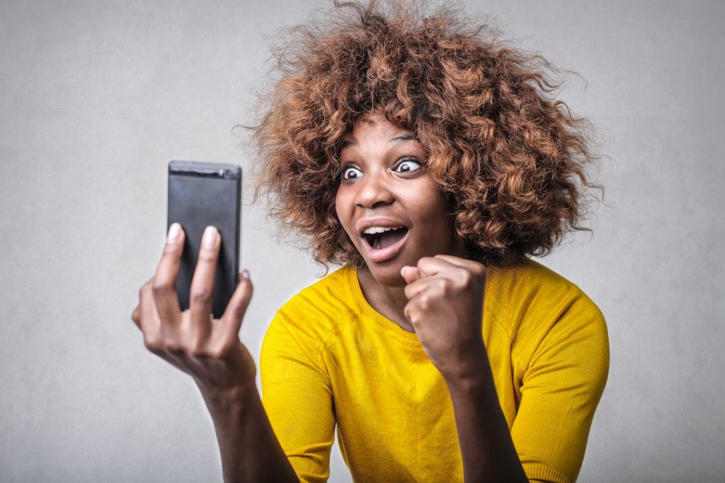 Excited Woman Looking at Phone